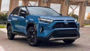 A blue 2023 Toyota RAV4 Hybrid small hybrid SUV is parked.