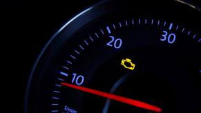 An illuminated Check Engine Light (CEL) on a Volkswagen Passat dashboard