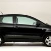 A exterior side profile shot of a black 2008 Volkswagen Fox hatchback