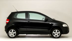 A exterior side profile shot of a black 2008 Volkswagen Fox hatchback