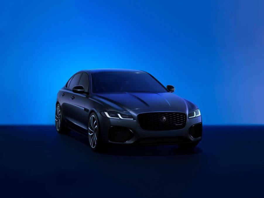 A promotion shot of a Jaguar XF Saloon midsize sports sedan in a blue-tinted room