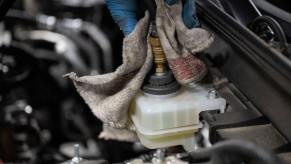 A brake fluid change performed by a garage mechanic on a Mazda MX-30 electric SUV model