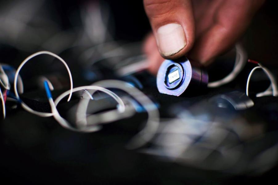 A McLaren Formula One mechanic fixing and placing electronic sensors in a race car for the Brazilian Grand Prix