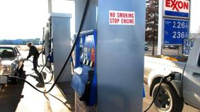 A gas station attendant at an Exxon station in Eugene, Oregon, pumping gas for a customer