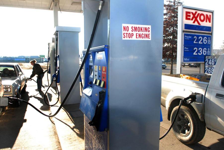 A gas station attendant at an Exxon station in Eugene, Oregon, pumping gas for a customer