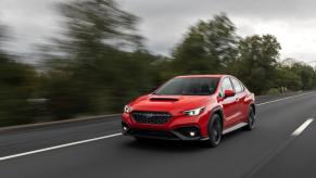 A 2022 Subaru WRX all-wheel drive (AWD) compact sports car/sedan model speeding down a road