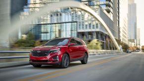 A 2024 Chevy Equinox RS compact crossover SUV model in the Radiant Red Tintcoat paint color option.