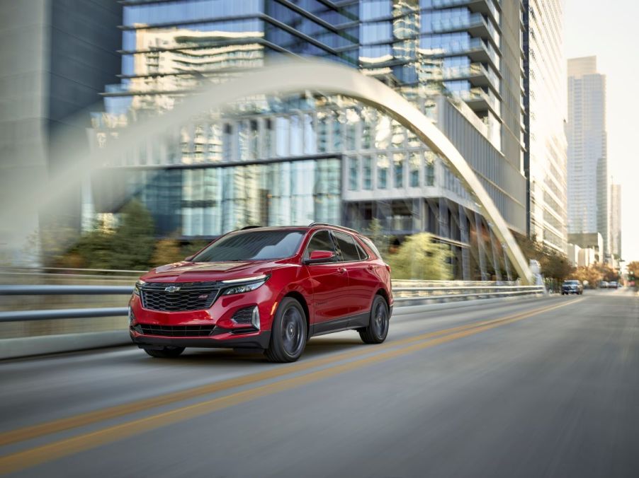 A 2024 Chevy Equinox RS compact crossover SUV model in the Radiant Red Tintcoat paint color option.