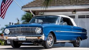 A blue and white 1963 Ford Falcon Futura Convertible shows off its fascia and soft top.