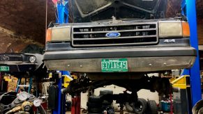 A 1988 Ford F-150 sitting on a lift in a garage.