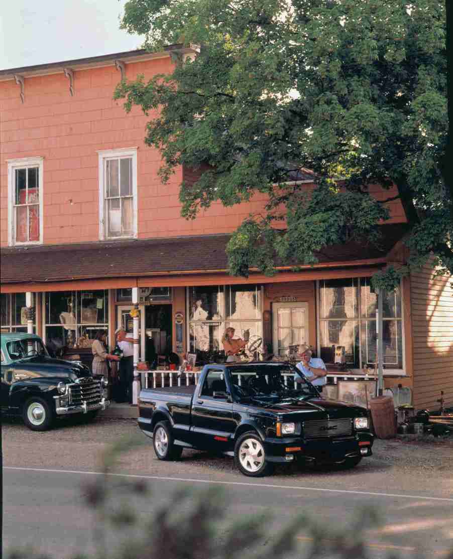 1991 GMC Syclone parked on a street in a rural town.