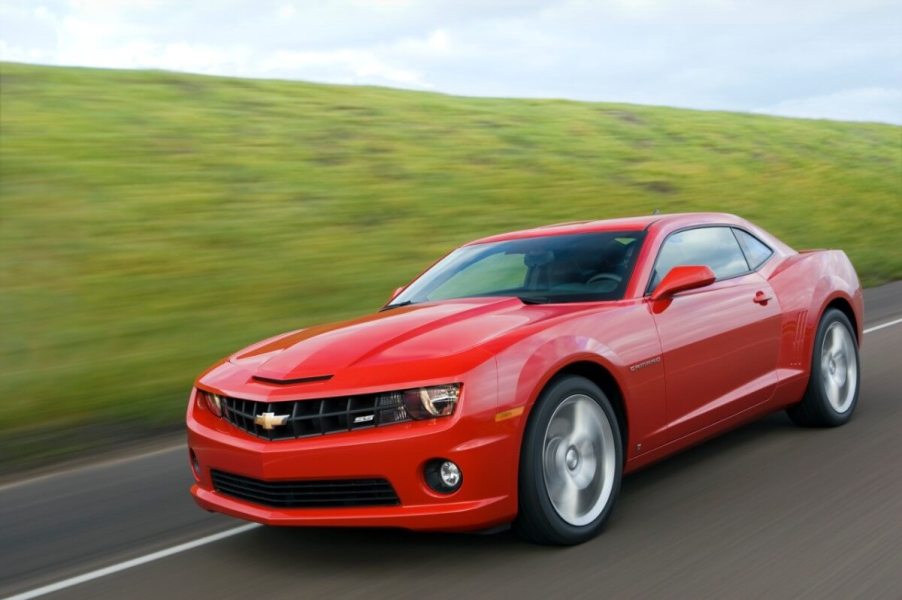 A red 2010 Chevy Camaro SS blasts down a country road.