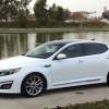 A white 2014 Kia Optima SXL, a reliable used Kia Optima model year