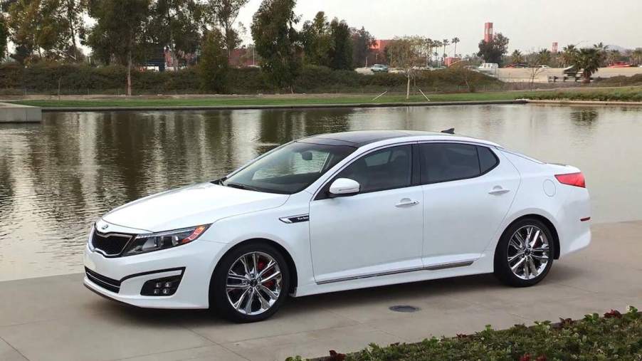 A white 2014 Kia Optima SXL, a reliable used Kia Optima model year