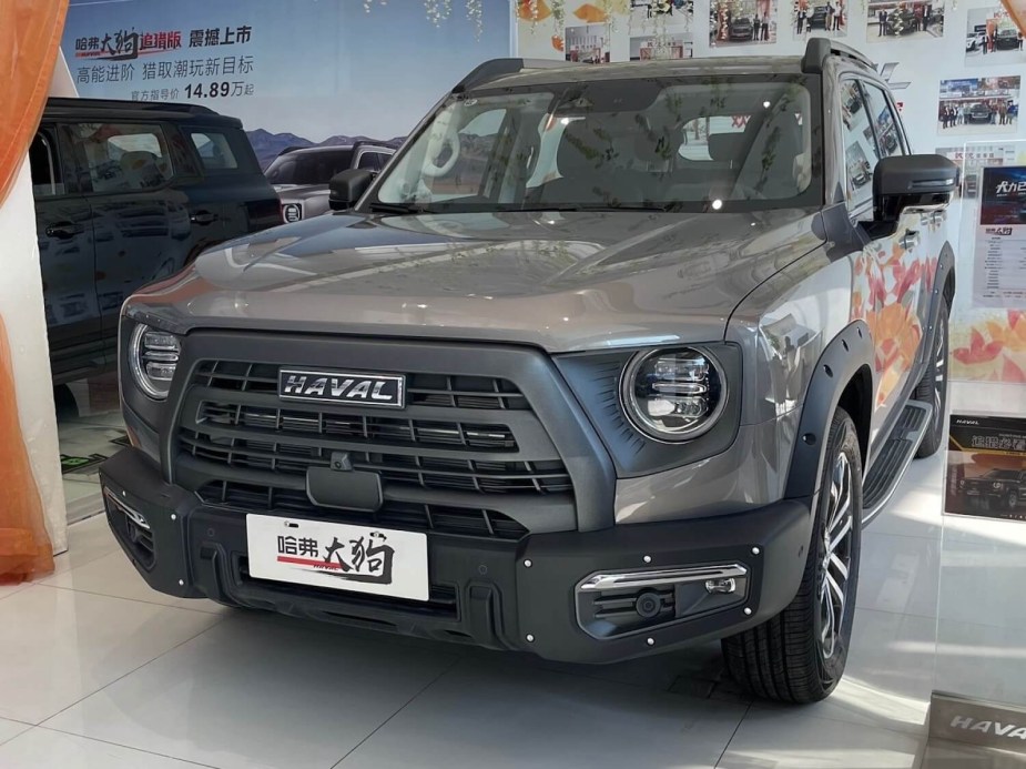 Green, special edition crossover SUV made in China and parked inside a dealership.