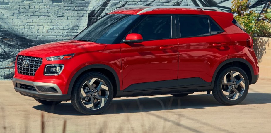 A red 2023 Hyundai Venue subcompact SUV is parked. 