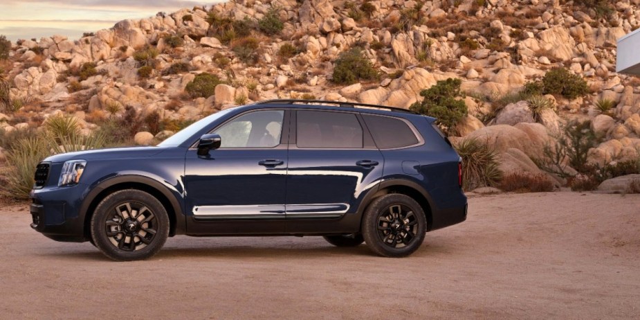 A blue 2024 Kia Telluride midsize three-row SUV is parked. 