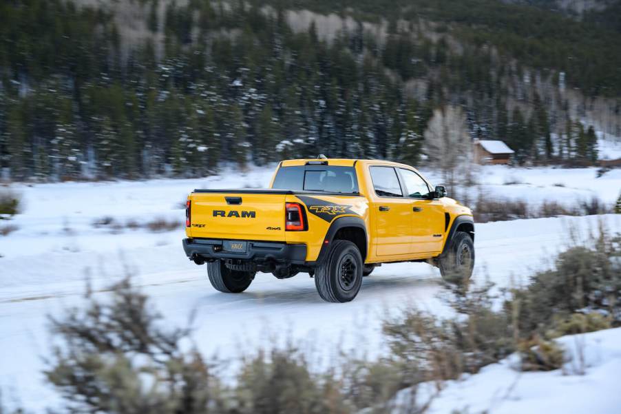 A special-edition Ram 1500 off-road truck in a unique yellow color driving through a snowy field.