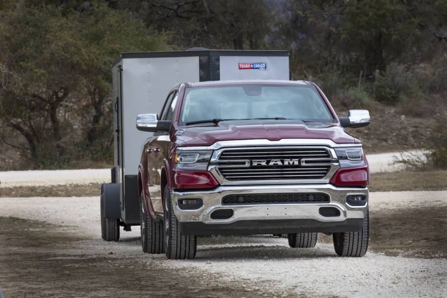 Red Ram 1500 pickup truck towing a trailer.