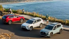 Three Toyota RAV4 small SUVs are parked.