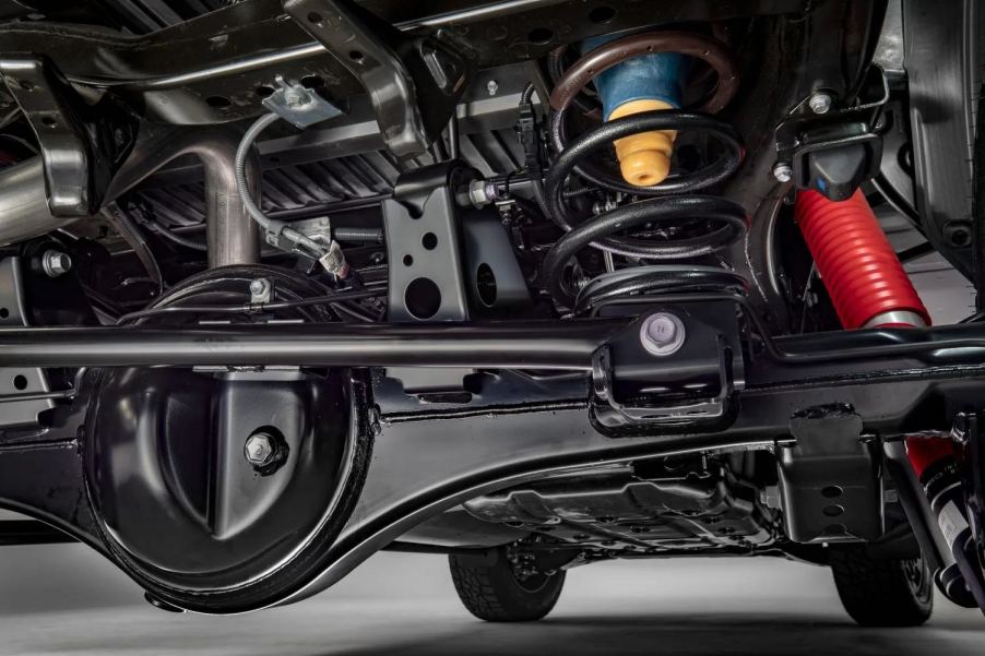 Closeup of the coil spring rear suspension under a modern Toyota Tundra.