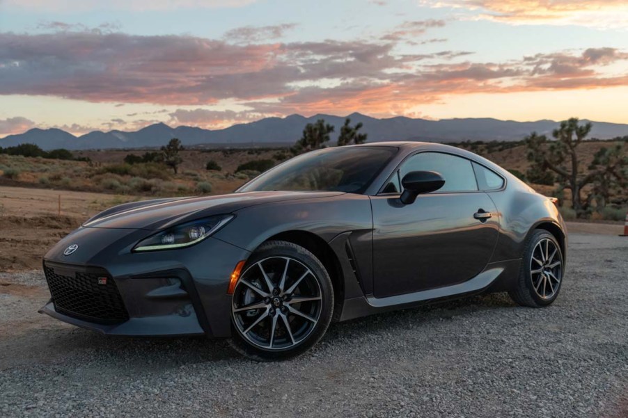 Front 3/4 of a 2023 Toyota GR86 sports car sitting in a California desert sunset