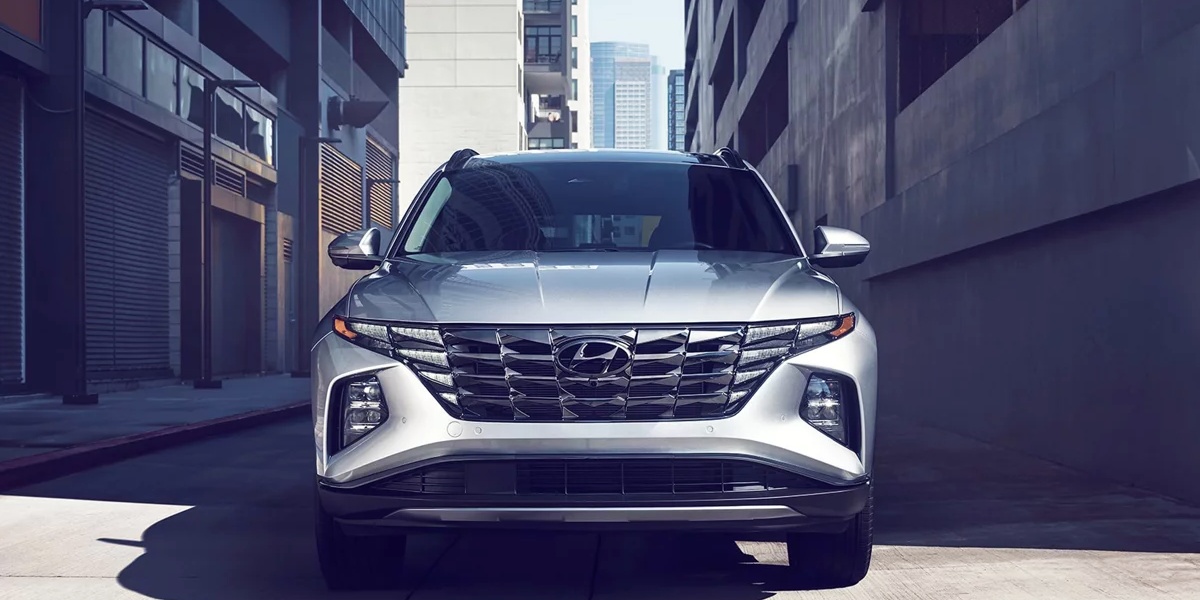 A gray 2024 Hyundai Tucson small SUV is parked.