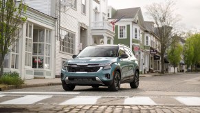 The 2024 Kia Seltos in Photon Blue on a residential street. The 2024 Kia Seltos trims are good except perhaps the EX configuration.