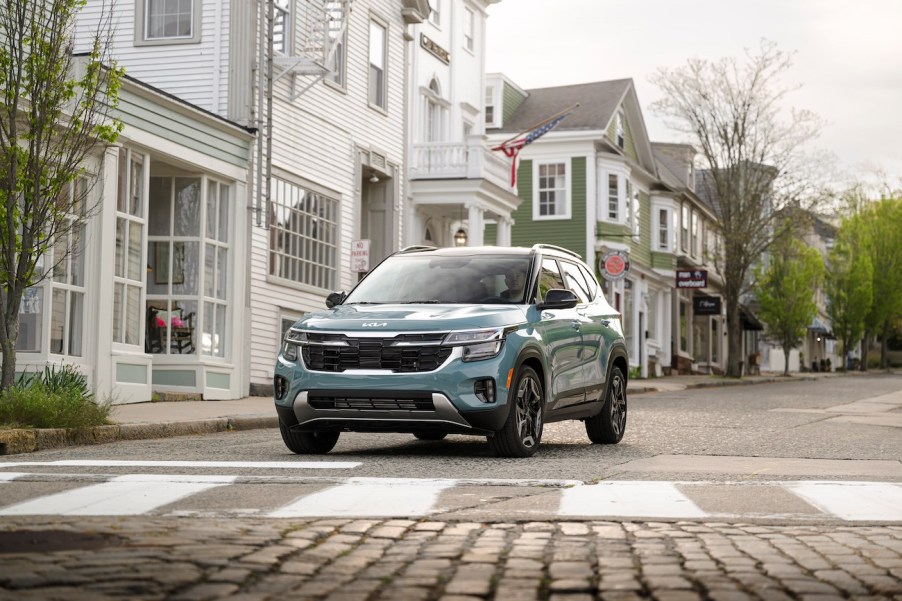 The 2024 Kia Seltos in Photon Blue on a residential street. The 2024 Kia Seltos trims are good except perhaps the EX configuration.