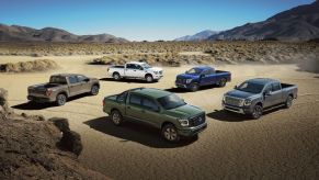 2024 Nissan truck lineup parked in the desert.