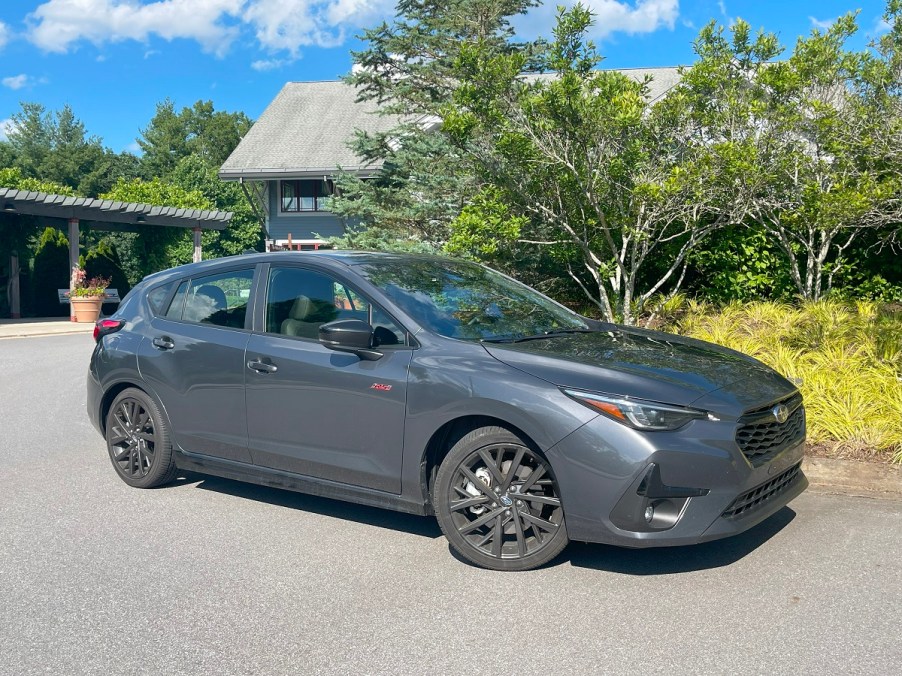 The 2024 Subaru Impreza RS parked near foliage