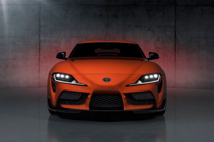 An orange 2024 Manual Toyota Supra 3.0 shows off its front-end styling.