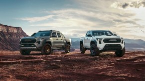 Two Toyota Tacoma midsize pickup trucks are parked.