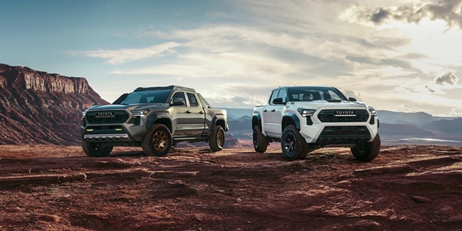 Two Toyota Tacoma midsize pickup trucks are parked.