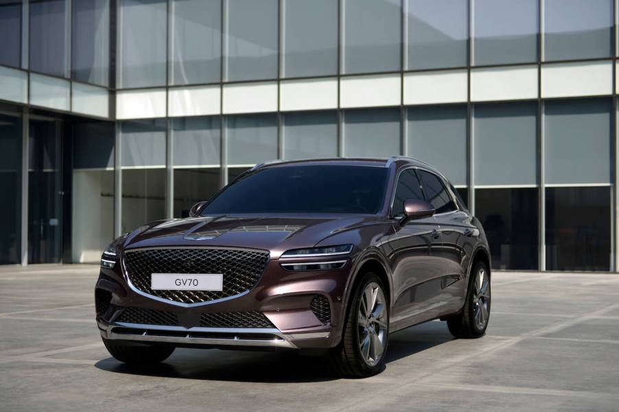 The Genesis GV70 parked in front of an office building. This is the most affordable Genesis SUV available.