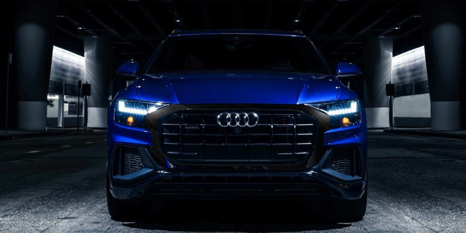 A blue Audi Q8 midsize SUV is parked. 