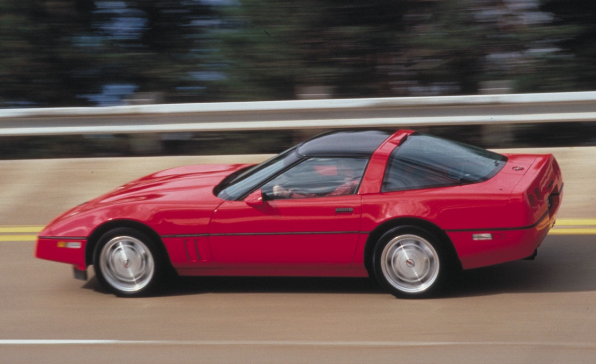 A red C4 Chevy Corvette ZR-1 cruises on a banked track. 