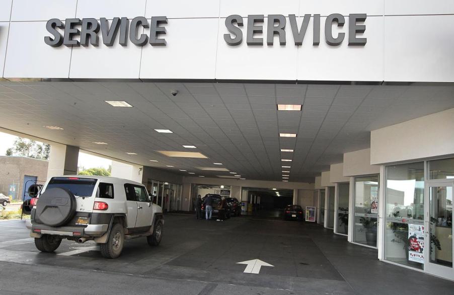 Cars waiting in line at a service station to have a recall repaired.