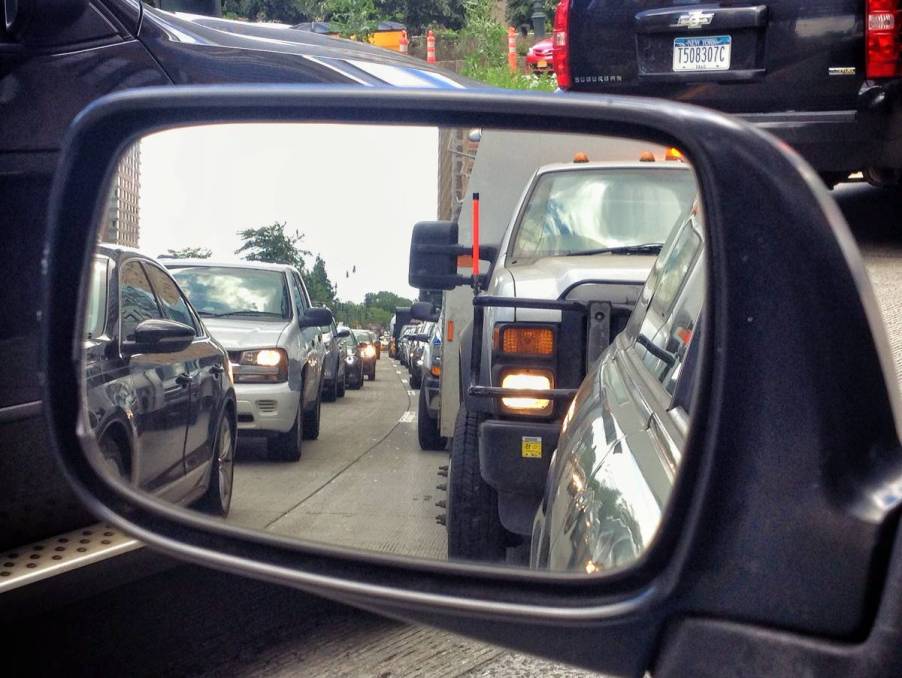 A view of traffic from a car's side view mirrors.