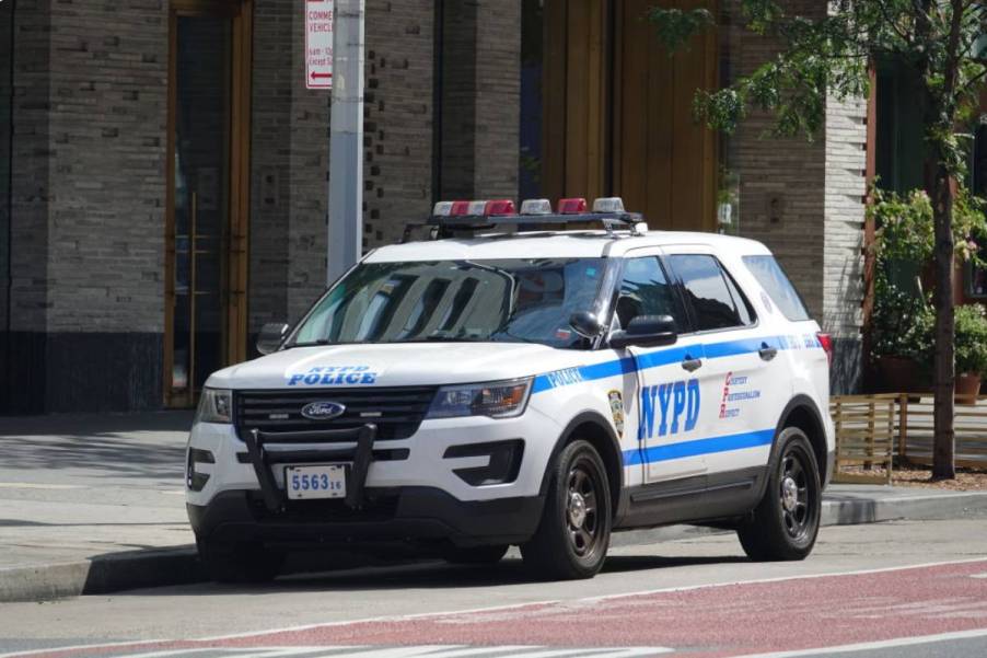 A Ford Explorer police car parked on the side of the street.