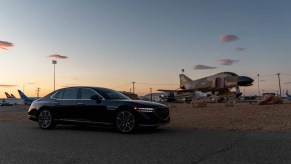 Blue Genesis G90 luxury sedan shot with F4 Phantom jet airplane