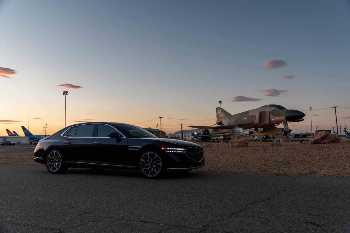 Blue Genesis G90 luxury sedan shot with F4 Phantom jet airplane