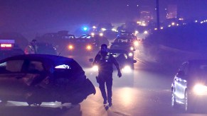 Lights shine in dense fog in a highway pileup