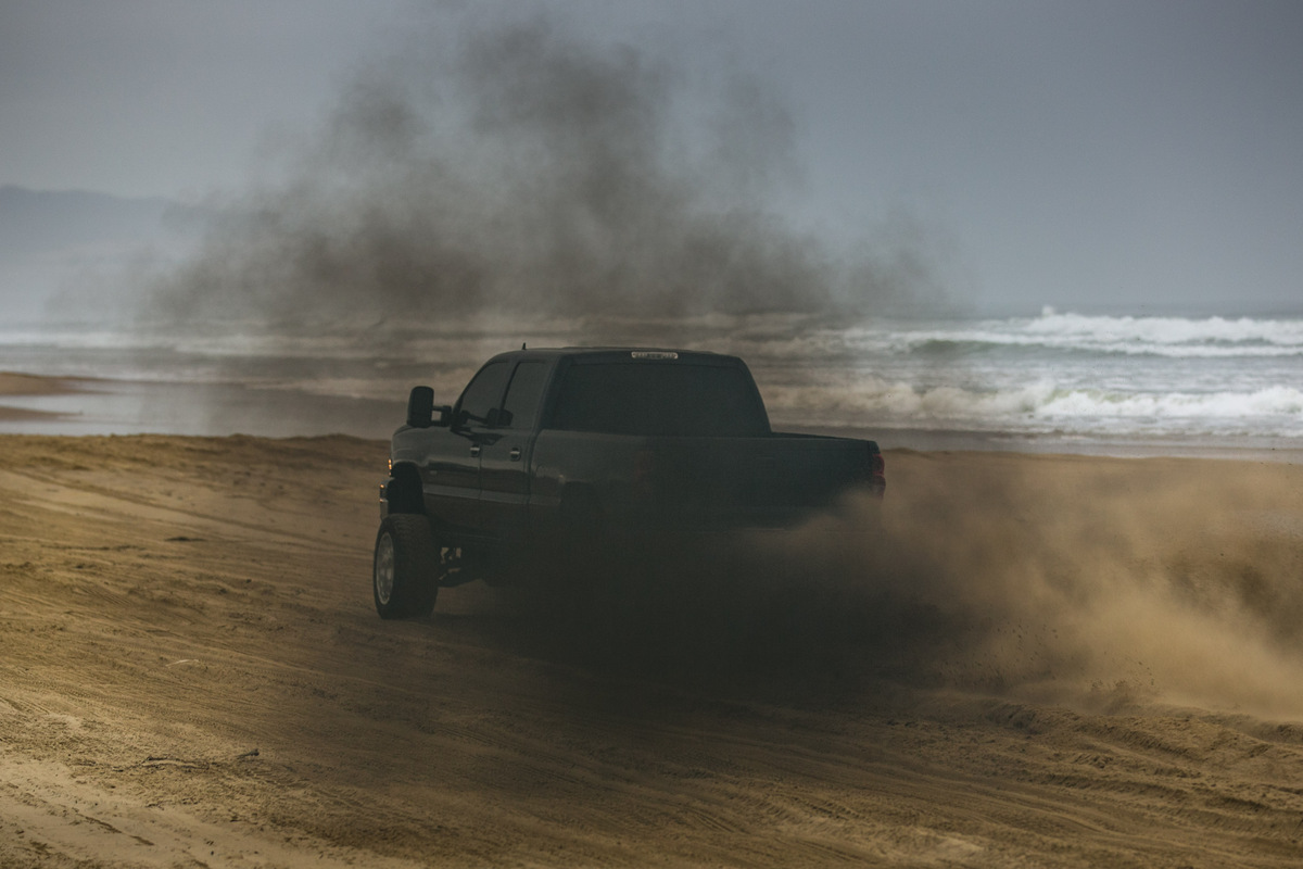 Black pickup Truck rolling coal