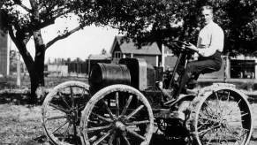 Henry Ford sitting on an early Ford automobile with the Model B engine in 1904