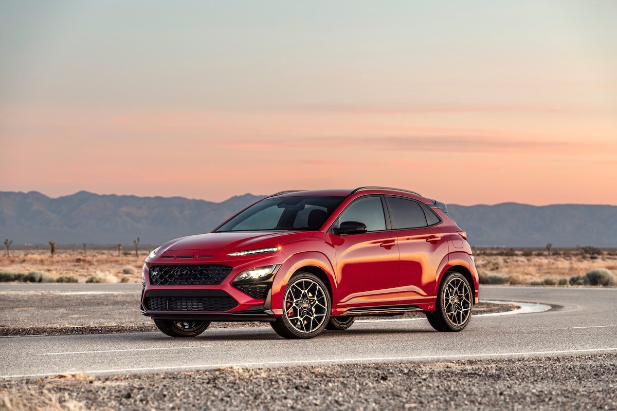 A red Hyundai Kona N parked at dusk