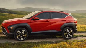 A red 2024 Hyundai Kona is parked.