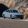 A gray 2023 Hyundai Elantra on a road next to a mountain. Hyundai sales for the Elantra are trending up