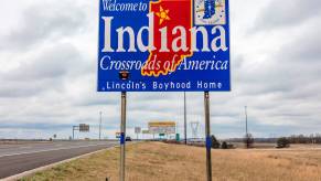 A welcome to Indian sign on interstate highway I-70, a major semi-truck thoroughfare.