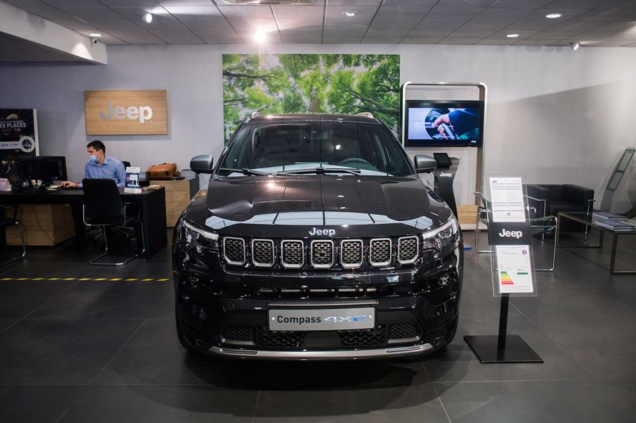 Black Jeep Compass 4xe on display in a showroom. Jeep Compass owners have a lot to say about their SUV.